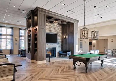 Interior common area with a pool table and fireplace