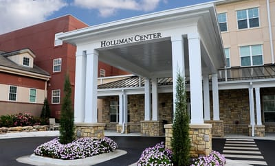 Entrance of the Holliman Center with landscaped flowers