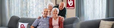 Group of smiling seniors in a comfortable living room