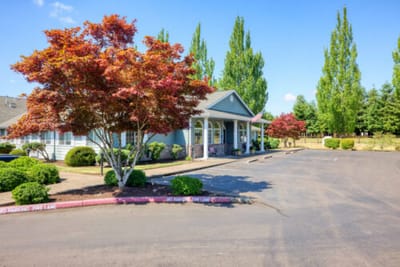 Exterior view of Bridgecreek Memory Care with colorful landscaping