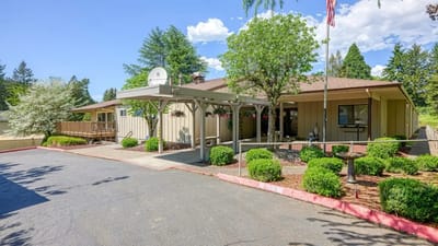 Exterior view of senior living facility with garden