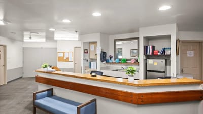 Front desk area of a senior living facility with a reception counter