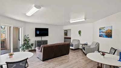 Bright common area with seating and TV