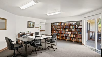 Bright common area with bookshelves and meeting space