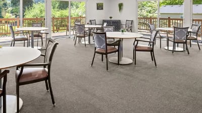 Bright dining room with tables and chairs in a shared space