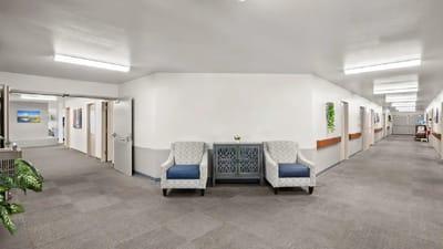 Well-lit interior hallway with seating area