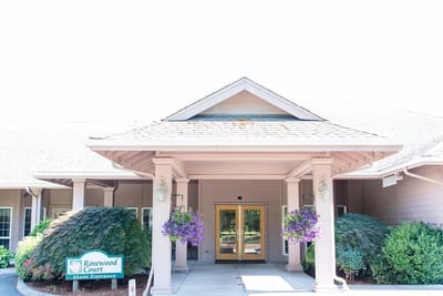 Main entrance of Rosewood Court with flowers and signage