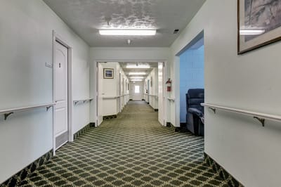 A well-lit corridor in a senior living facility