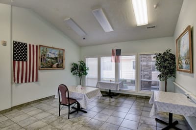 Bright common area with tables and American flags