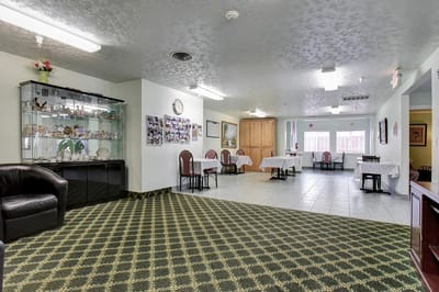 Common area with tables and chairs in a residential care facility