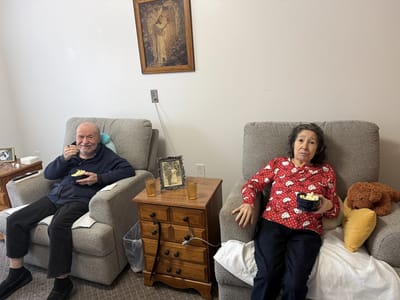 Two residents enjoying snacks in a cozy common area
