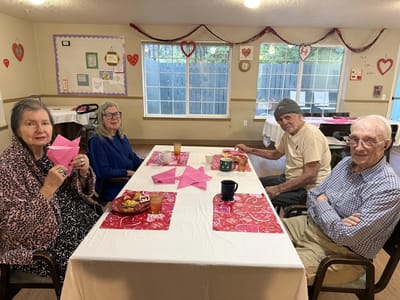 Residents enjoying craft activities at a dining table