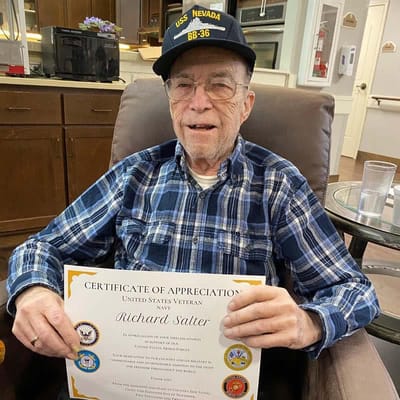 Resident holding a certificate of appreciation