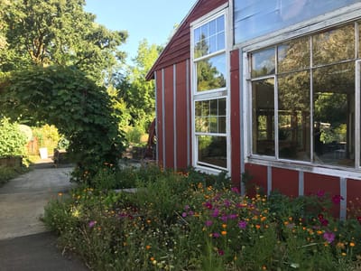 Exterior view of a facility with garden flowers