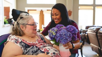 Staff member assisting resident with flowers
