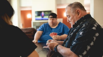 Residents playing cards in a common area