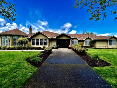 Exterior view of Conifer House with lawn and entrance