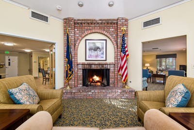 Interior common area with a fireplace and seating