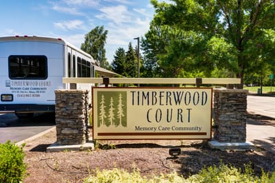 Sign for Timberwood Court Memory Care Community at the entrance