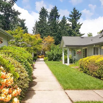 Pathway lined with flowers and greenery at Magnolia Gardens