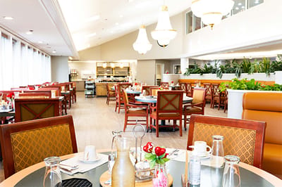 Bright dining room with tables set for a meal