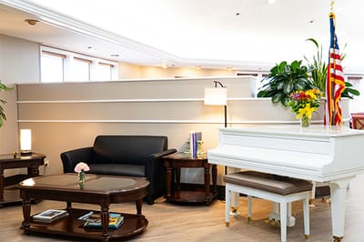 Warm and inviting common area with piano and seating