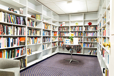 Cozy library filled with books and a table for reading