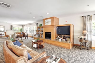 Spacious common area with seating and a fireplace