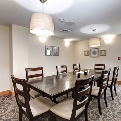 Bright common area with dining tables and chairs
