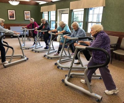 Residents participating in a group exercise activity inside the facility