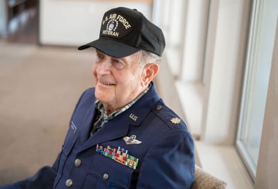 Senior veteran smiling in a common area