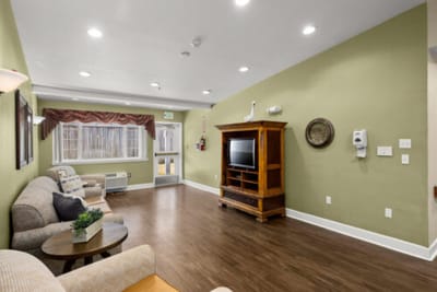 Bright common area with seating and television