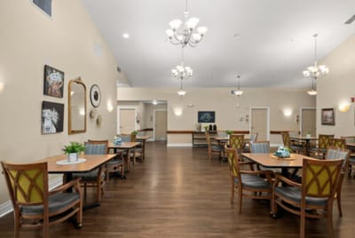 Bright common dining area with tables and chairs