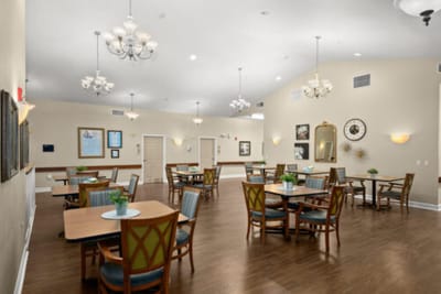 Bright common dining area with tables and chairs