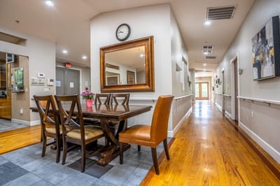 Bright communal dining area with wooden table and chairs