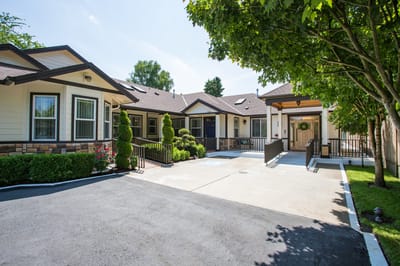 Exterior view of Mapleview Manor with landscaped entrance
