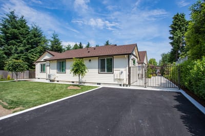 Exterior view of Mapleview Manor with a landscaped area