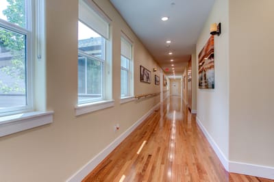 Brightly lit hallway with wooden flooring