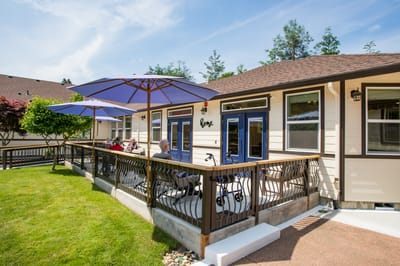 Residents enjoying the outdoor patio with umbrellas