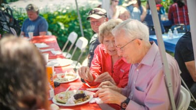 Residents enjoying a meal together during an outdoor event