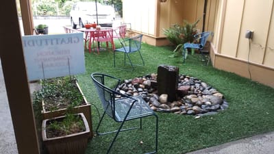 Outdoor seating area with tables and decorative stones