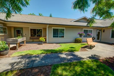 Outdoor area with seating and garden beds