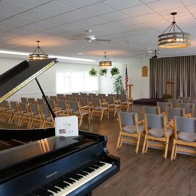 Interior view of a multi-use room with seating and piano