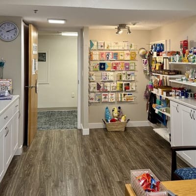 Interior view of a small shop area with cards and personal items