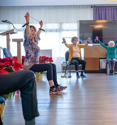 Residents participating in a group exercise class indoors