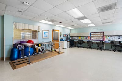 Interior view of a rehabilitation area with exercise equipment