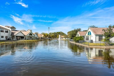 View of a tranquil lake with surrounding buildings