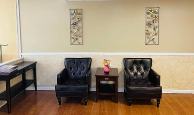 Cozy common area with black chairs and flowers