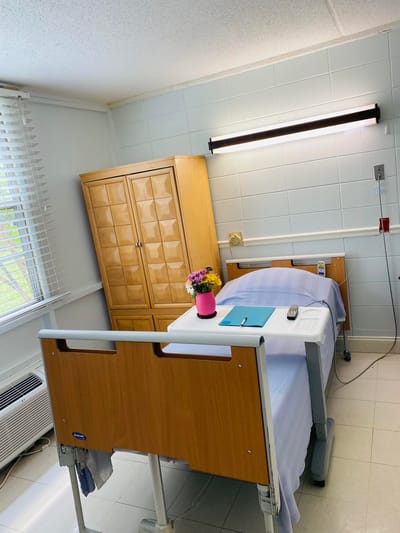 A patient room with a hospital bed and decor