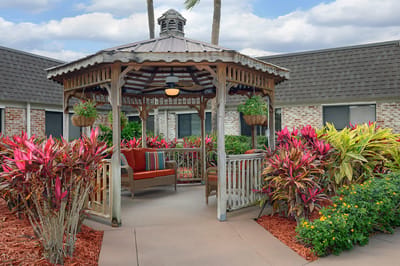 A gazebo surrounded by colorful landscaping